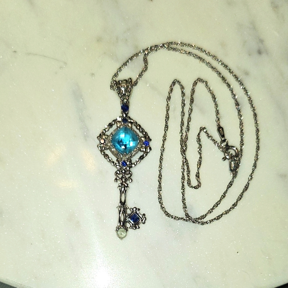 Intricate Silver Key Pendant Necklace with Blue Gemstone